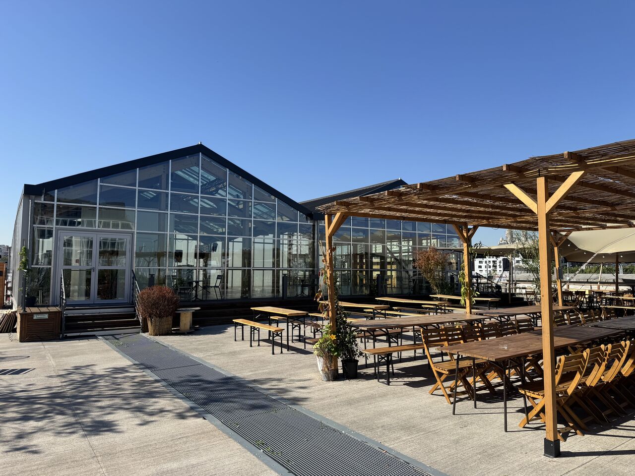Bar and café area overlooking a rooftop urban farm in Paris